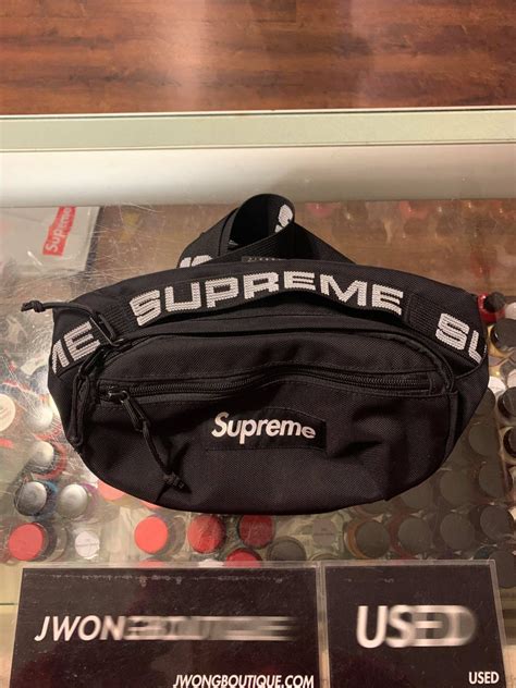 supreme bag around waist.